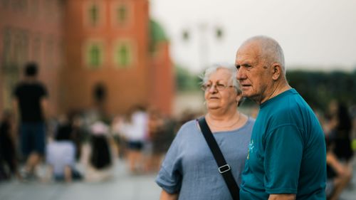 Free Senior couple enjoying a day out in a bustling city setting. Stock Photo