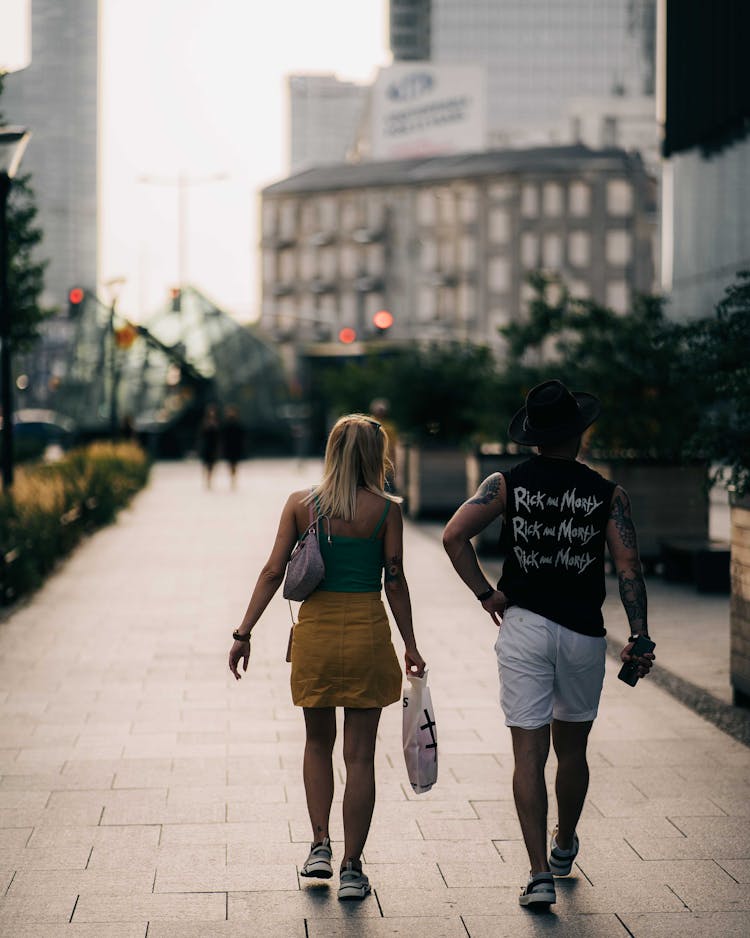 Back View Of A Man And Woman Walking Together 