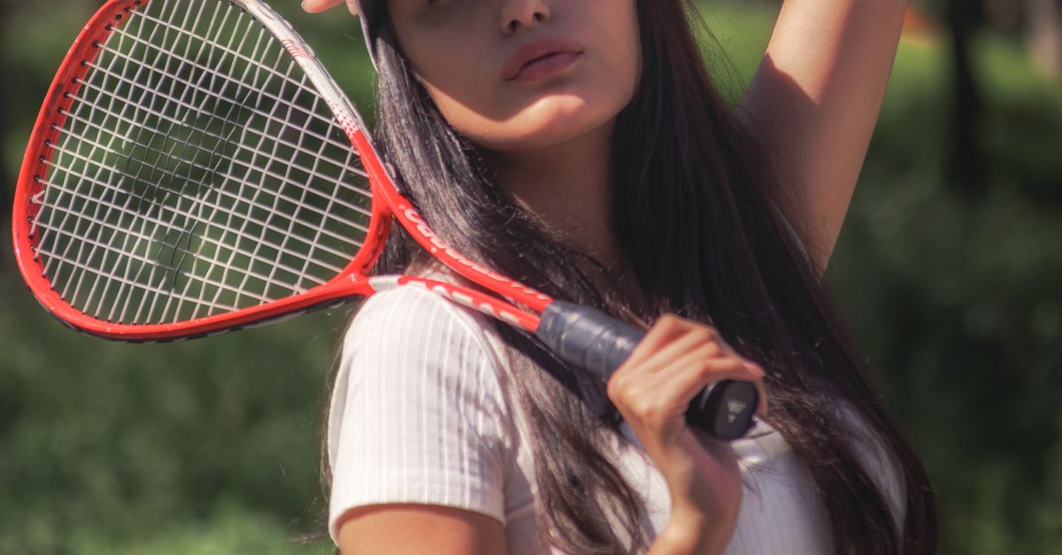 Photo Poses With Racket Woman Posing with a Tennis Racket · Free Stock Photo
