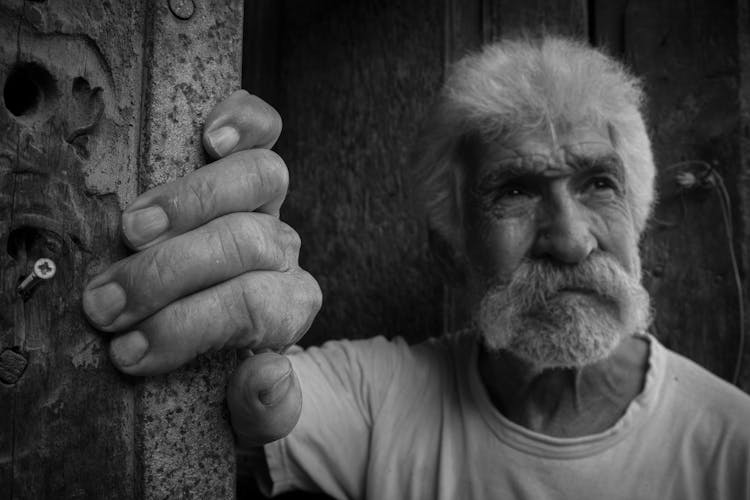 Old Man With Moustache Standing Near Wall