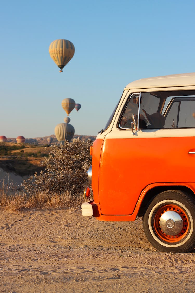 Van And Balloons On Sky Behind