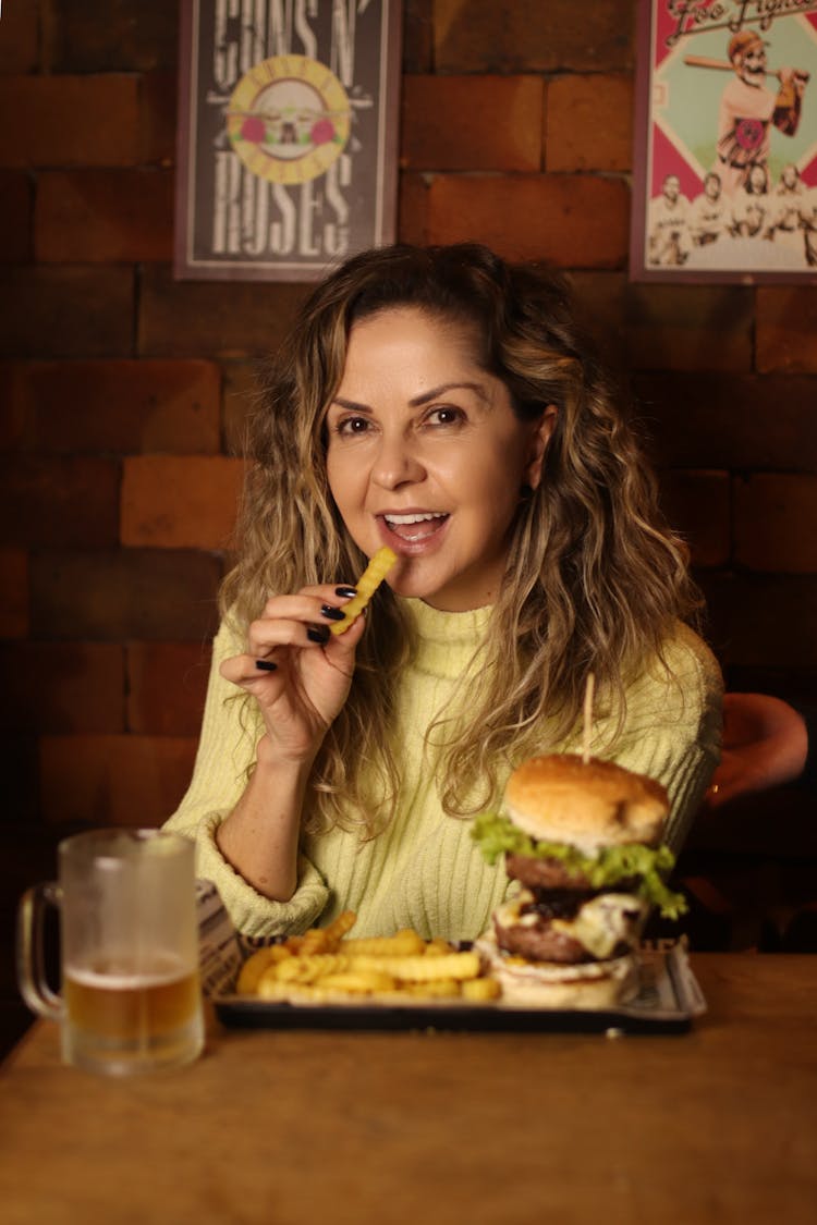 A Woman Eating French Fries