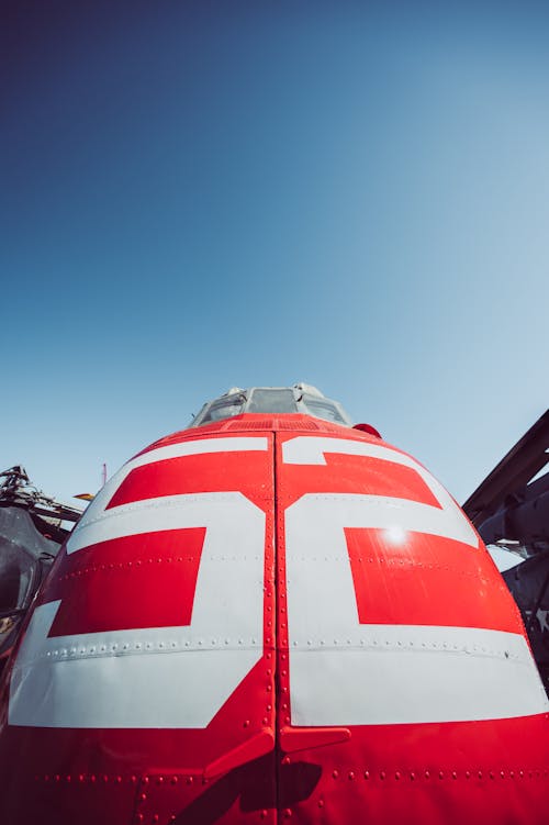 White and Red Airplane Under Blue Sky