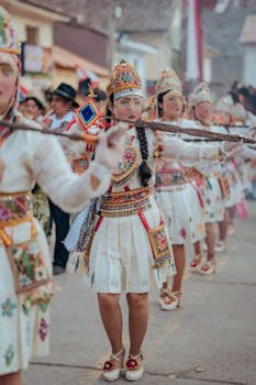 Vibrant traditional parade featuring dancers in ornate costumes on the street.