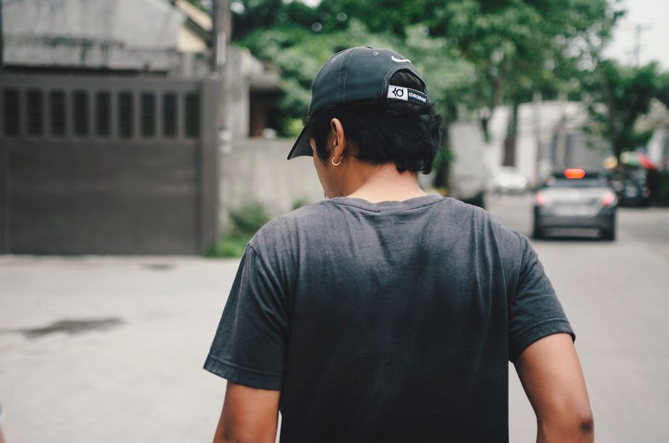red baseball cap sidewalk