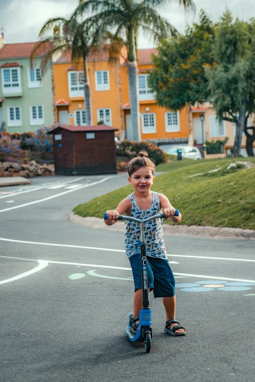 Happy Kid riding a Scooter 