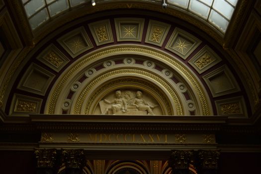 Intricate bas-relief and ornate ceiling inside The National Gallery in London, highlighting classical art.