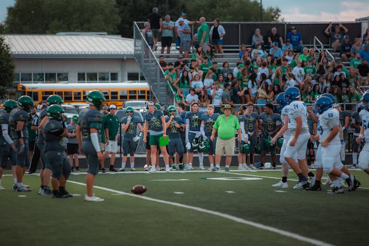 Football Players In The Field And Spectators On The Stand