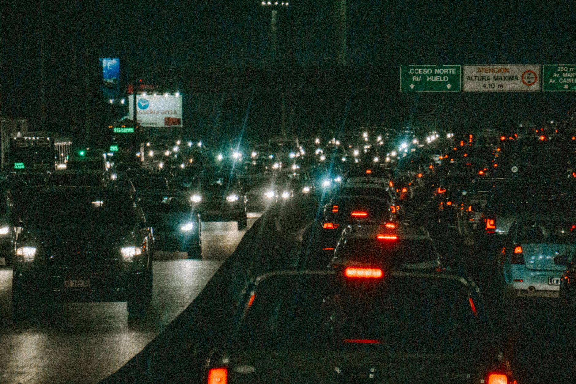 Evening traffic and lit shopfronts on a busy Nairobi avenue