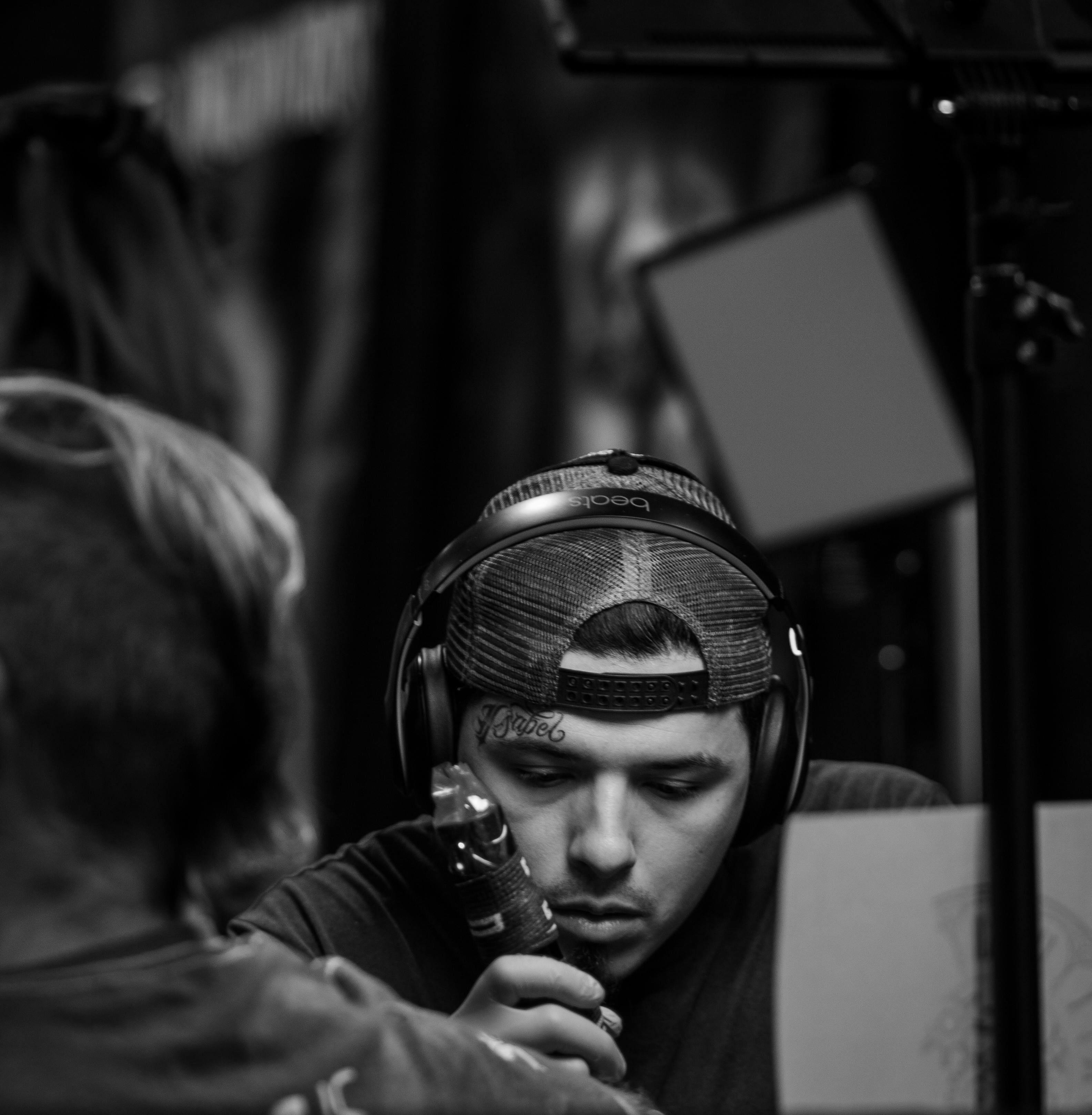 Monochrome image of a focused tattoo artist working in a studio in Dallas, TX.