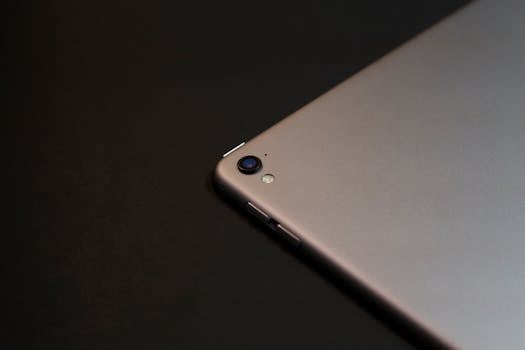 Close-up of a tablet camera on a dark background, emphasizing modern design.