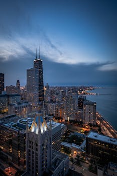 A breathtaking aerial view of Chicago's skyline featuring the iconic John Hancock Center at twilight.