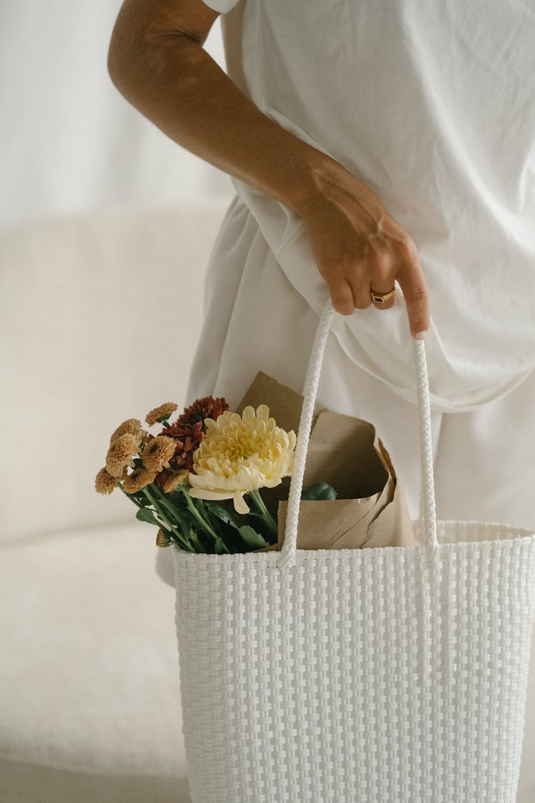 Woman Holding A Basket With Flowers 