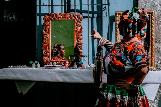 Traditional Mexican clothing reflected in a mirror during a celebration in Puebla, Mexico.