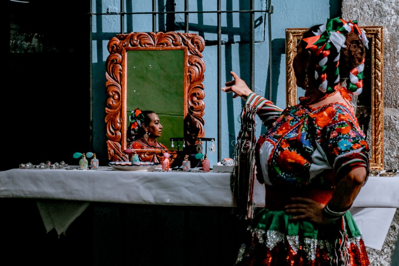traditional mexican clothing reflected in a mirror during a celebratio