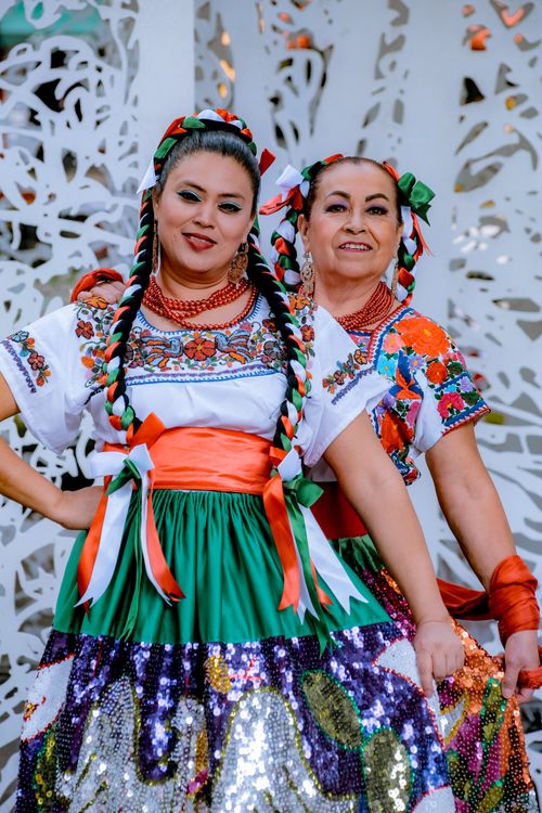 Free Women in traditional Mexican dresses celebrating cultural heritage. Stock Photo
