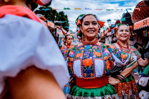 Free Colorful Mexican women celebrating cultural traditions in vibrant dress during Puebla festival. Stock Photo