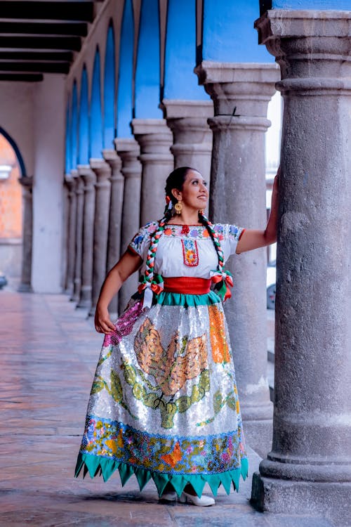 Free Woman in Mexican Folk Costume Posing by the Colonnade Stock Photo