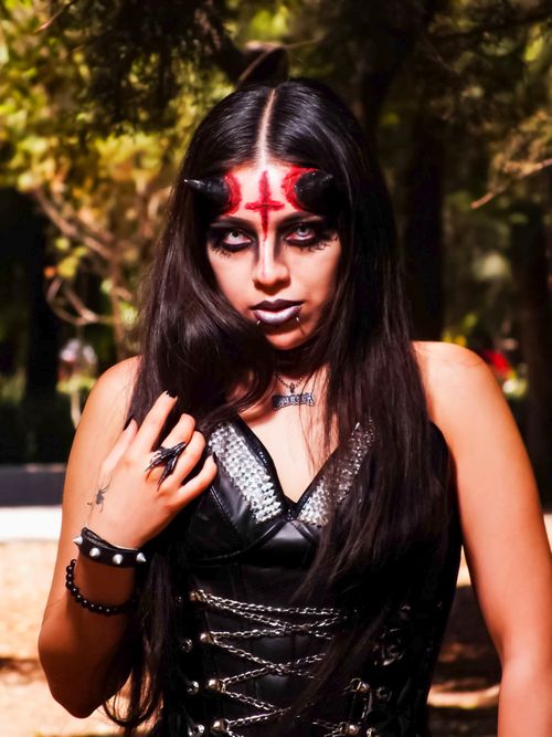 Free Portrait of a woman with gothic demon makeup and costume in Mexico City park. Stock Photo