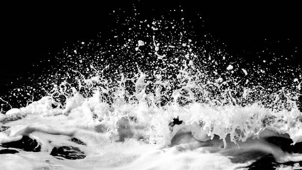 High contrast black and white splash of ocean waves, capturing dynamic motion.