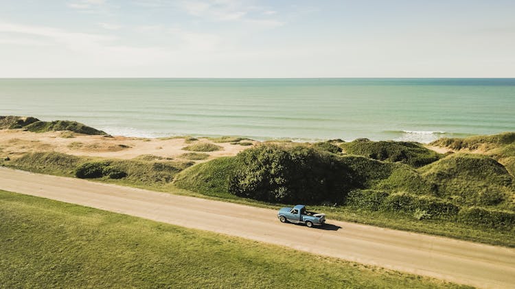 Car On Road Near Sea