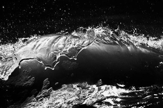 Capturing the powerful motion of an ocean wave in dramatic black and white.