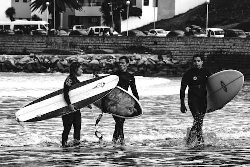 People with Surfboards in Ocean