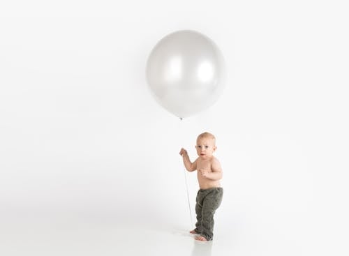Free Baby Holding White Balloon Stock Photo