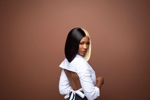 Backless fashion portrait of a model with striking two-tone hair in Miami.
