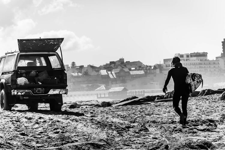 Woman Carrying A Bag To A Truck