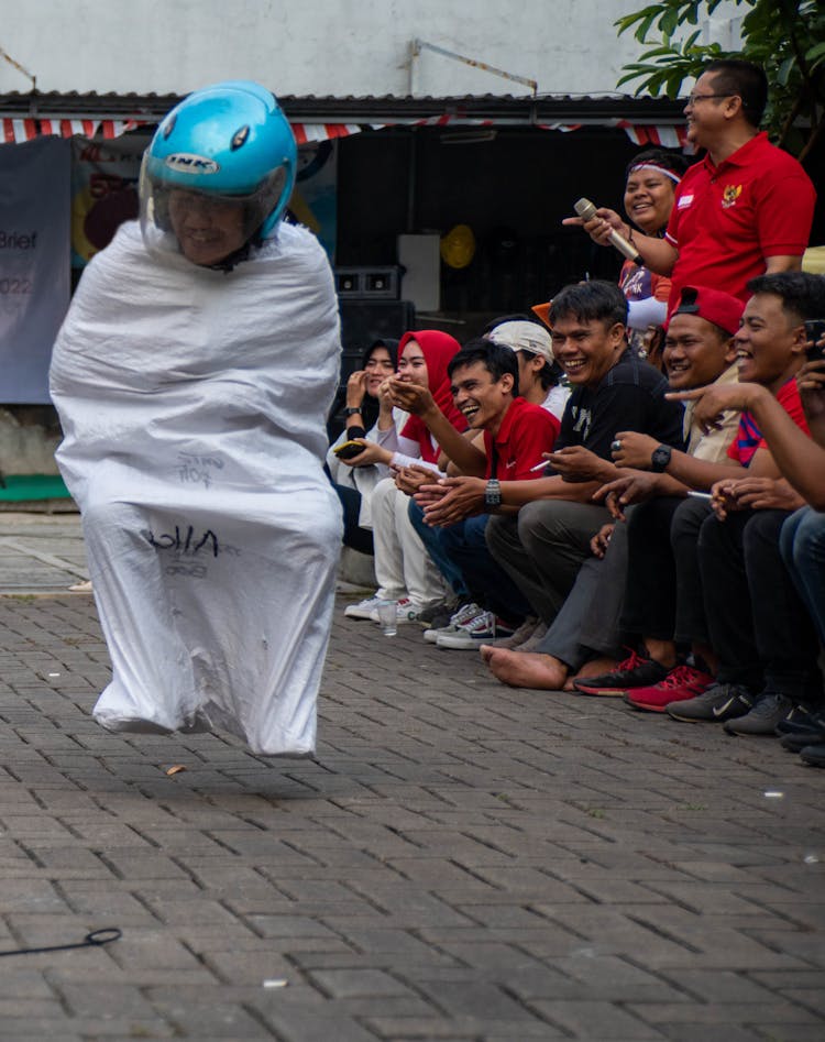 Crowd Of People Watching A Sack Race