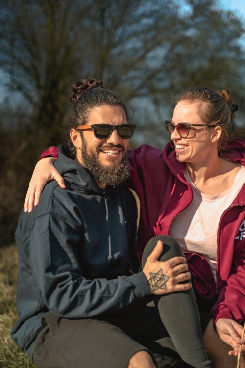 Free Smiling couple enjoy a sunny day outside, exuding happiness and warmth. Stock Photo