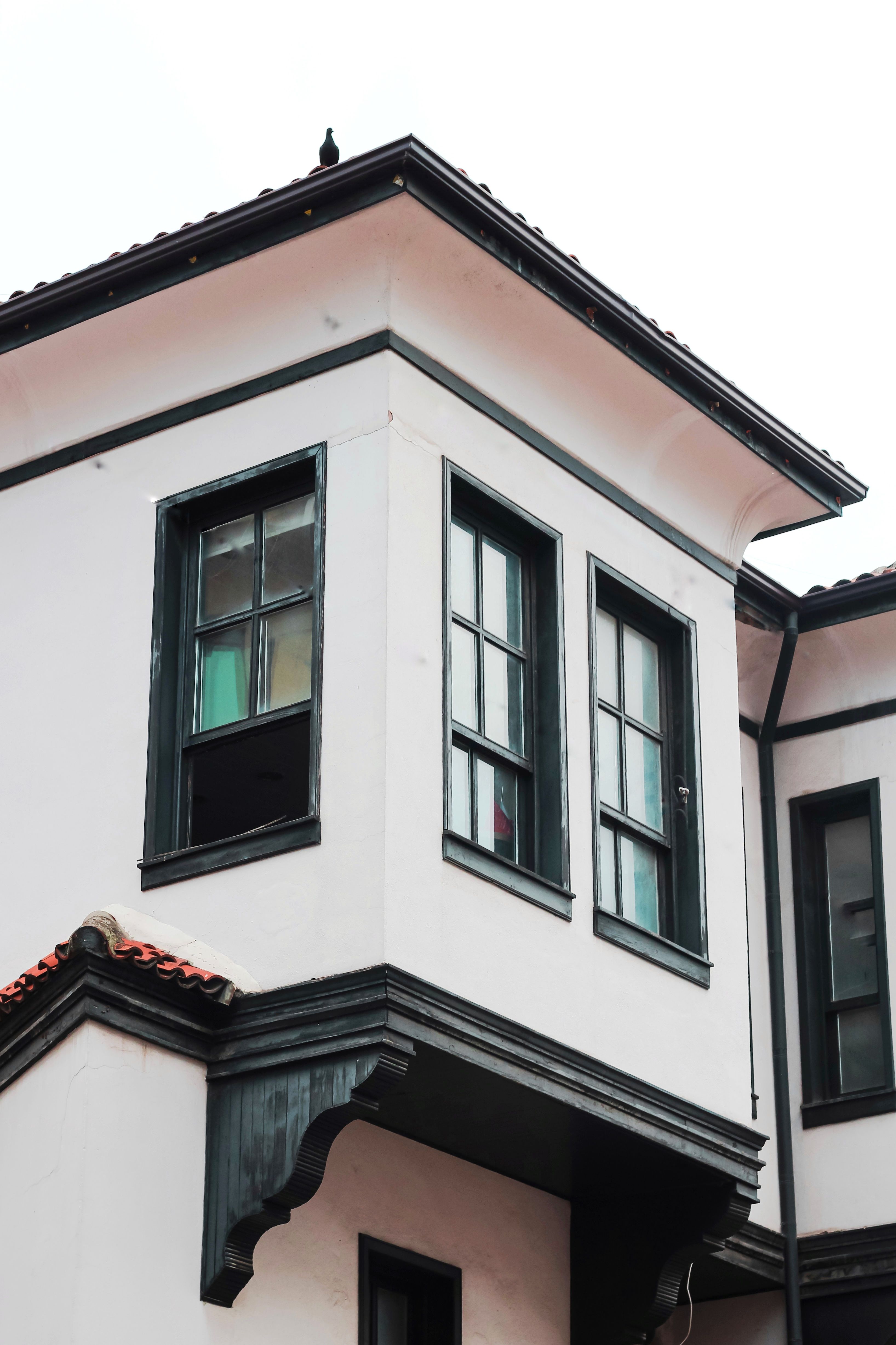 Close-up of a modern building facade featuring glass windows and architectural details.