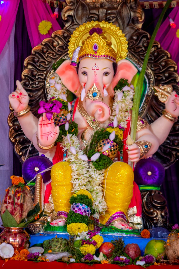 Fruit Offerings Under A Ganesh Statue