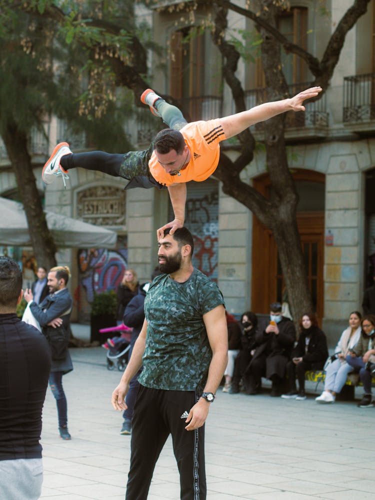 Men Acrobats Performing On A City Street