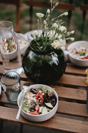 Fresh salad in a white bowl on a wooden table — Olena Bohovyk on Pexels