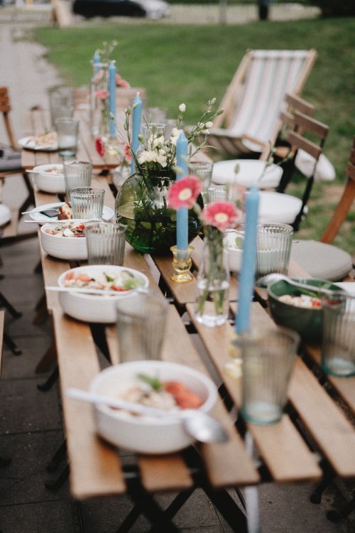 Free Beautifully set outdoor summer dining table with flowers and candles. Stock Photo