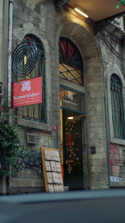 Free Charming entrance of a bookstore with a historic stone arch facade. Stock Photo