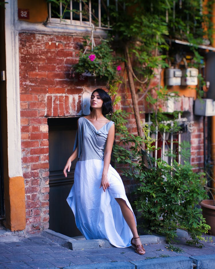 Woman In Elegant Dress Posing On Old Town Street