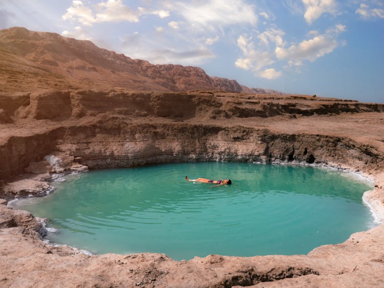 Woman Floating On Turquoise Lake