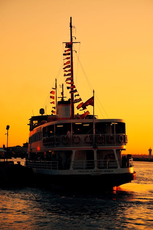 White and Black Ship on Sea during Sunset