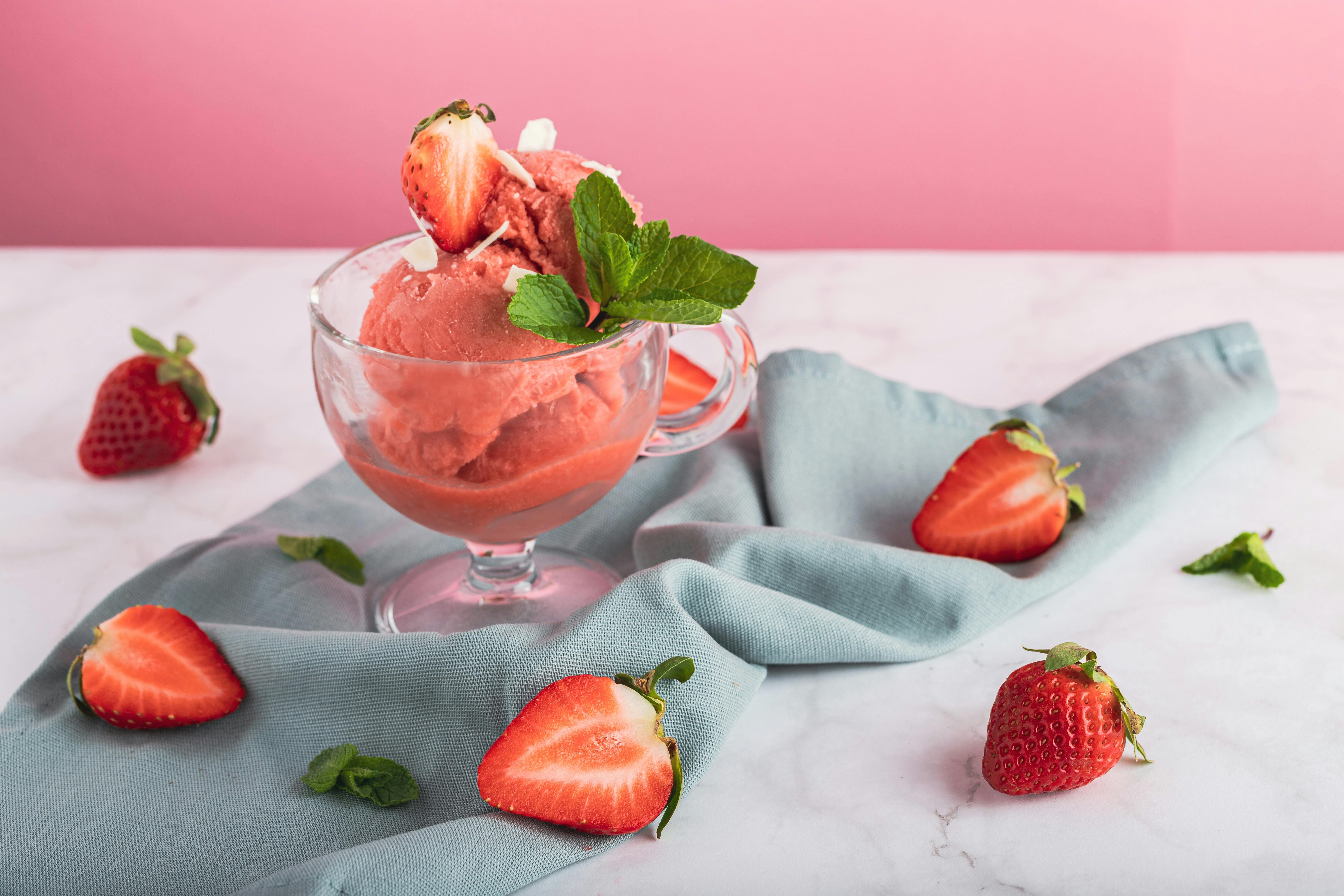 Ice cream ball with strawberry pieces Stock Photo by magone