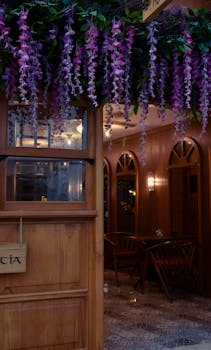Inviting restaurant entrance decorated with wooden elements and floral accents.