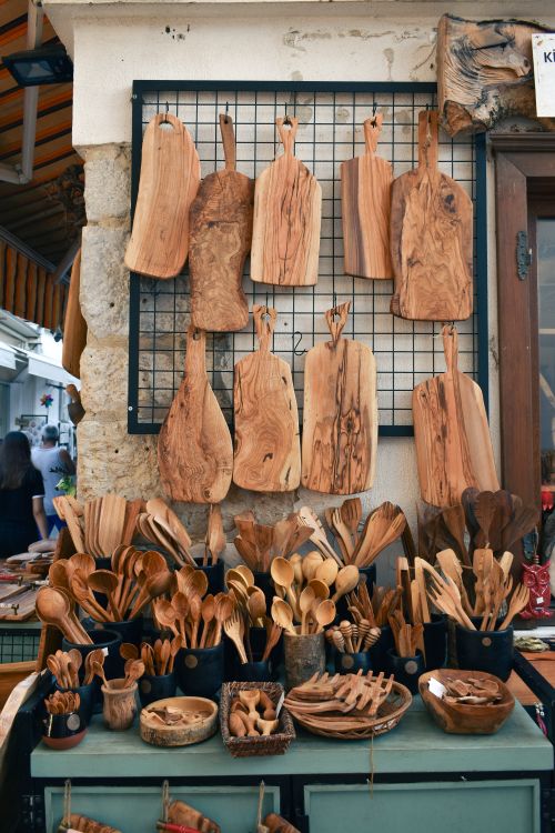 Free A vibrant display of handcrafted wooden kitchenware at an outdoor market stall. Stock Photo