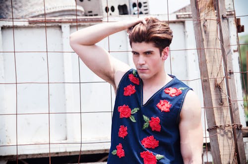 Man Wearing Floral Vest Holding His Hair