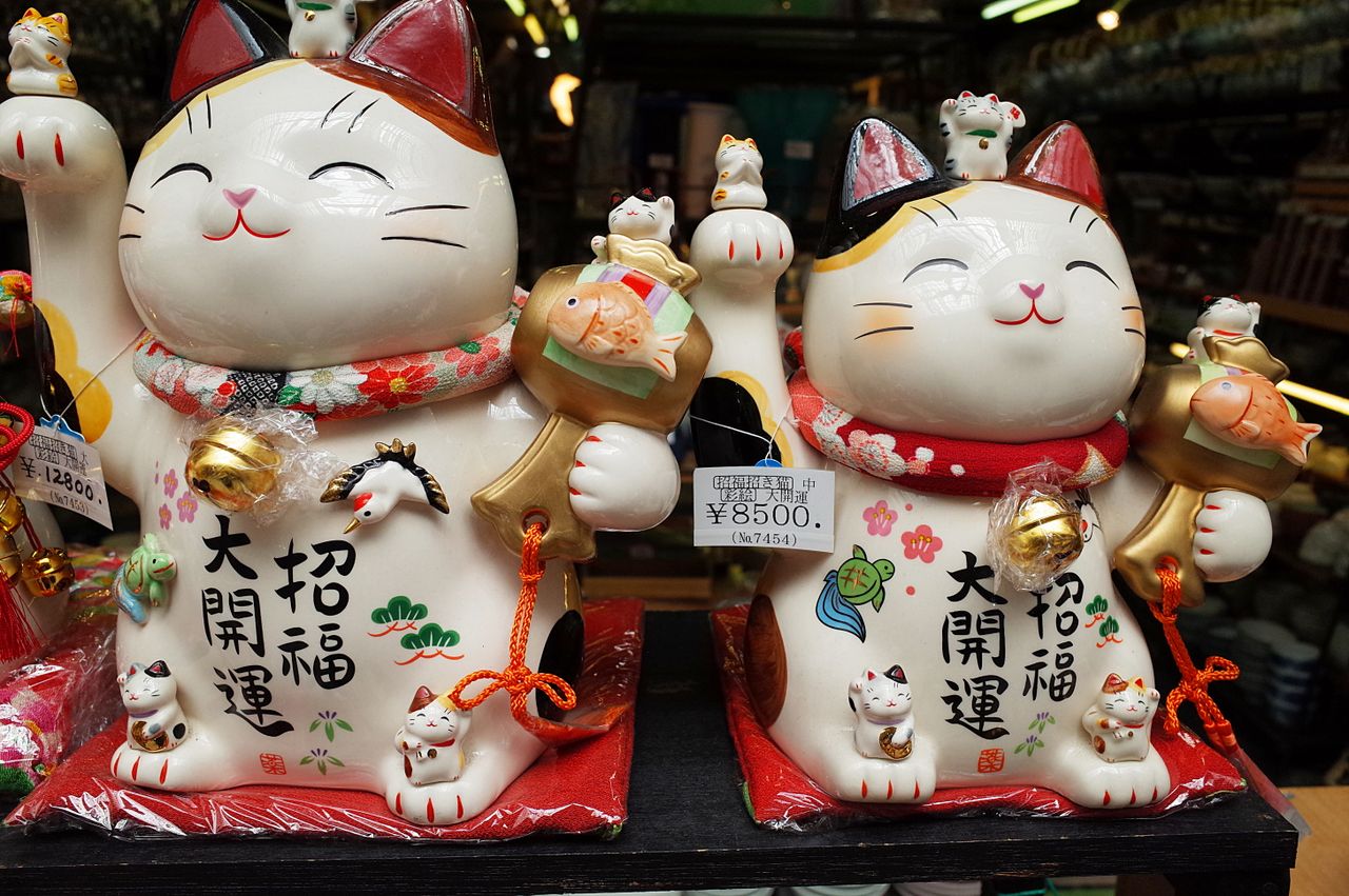 colorful ceramic maneki neko figurines displayed in a nagoya shop symb