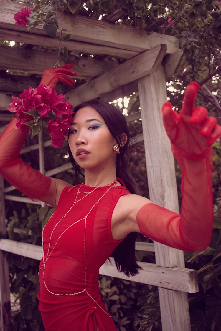 Woman In Red Dress And Gloves Posing In Garden