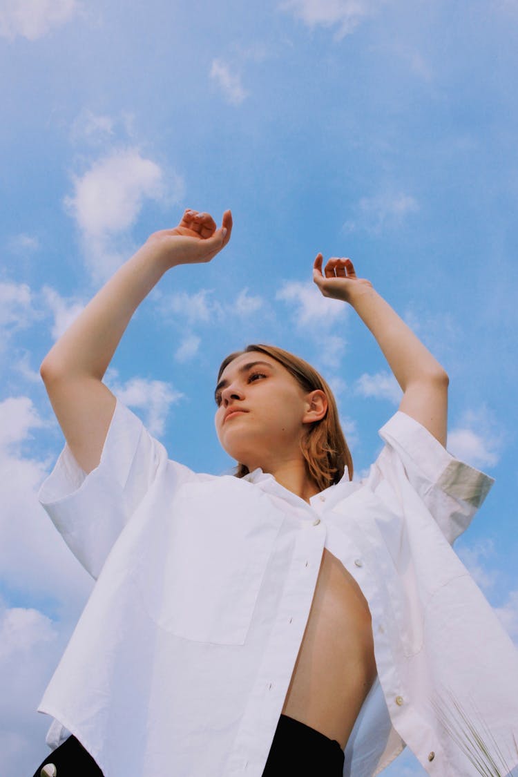 Woman In White Shirt On Blue Sky Background