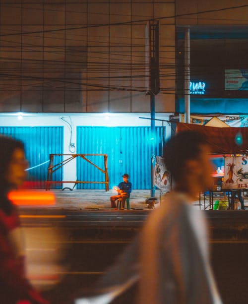 Man Sitting by the Street