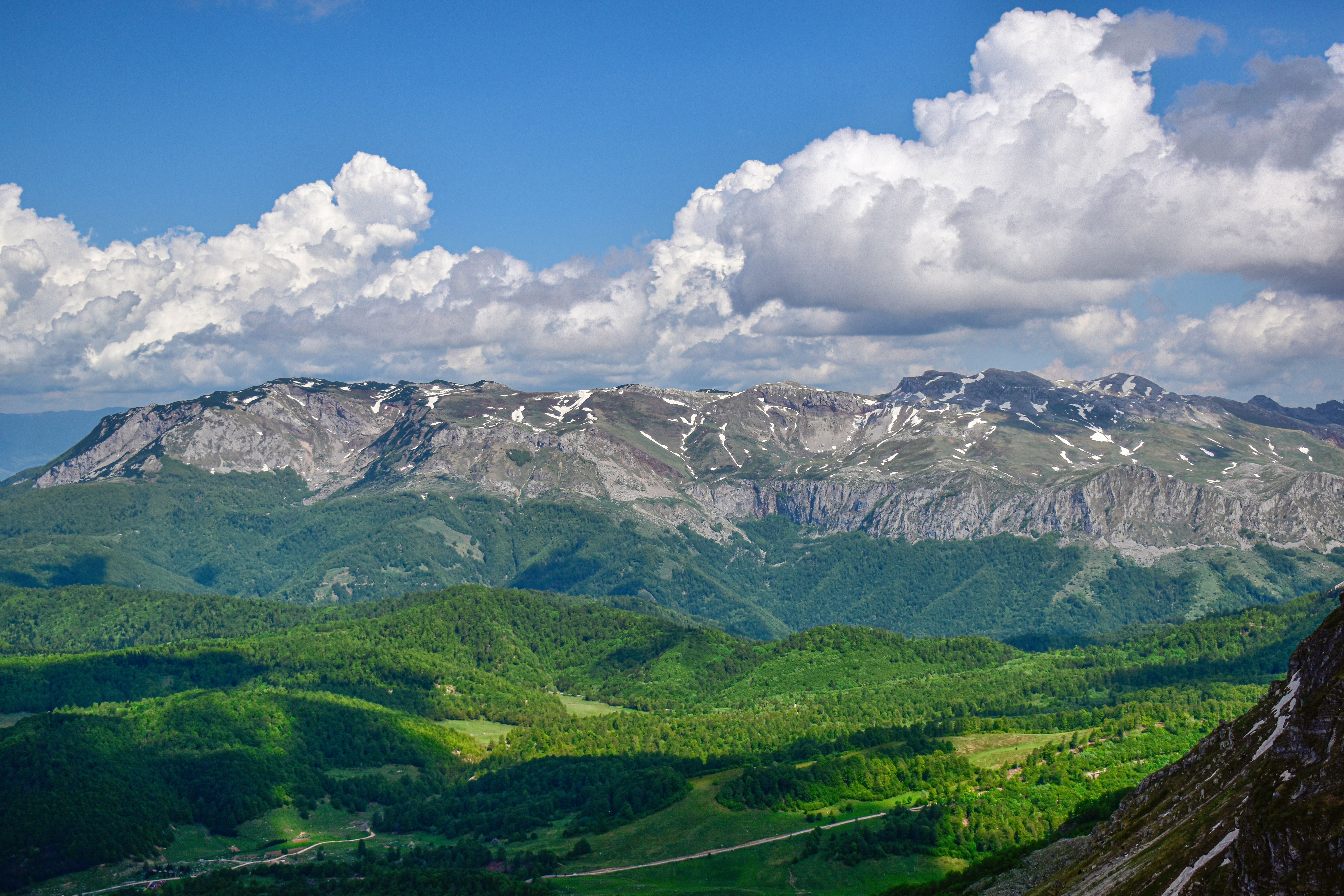 White Clouds and Blue Sky over a Mountain · Free Stock Photo